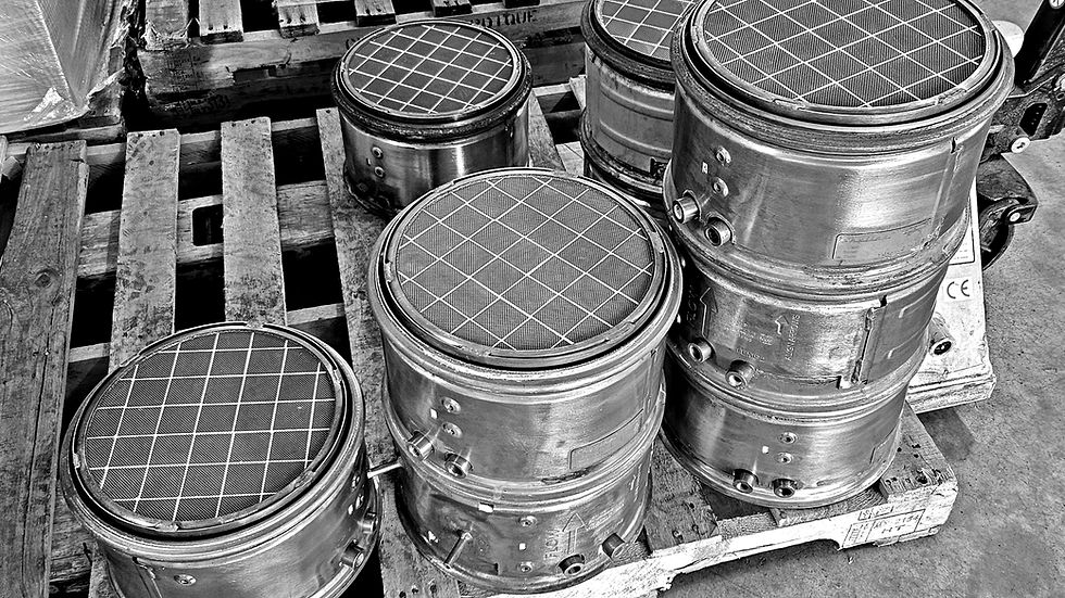 Stack of cleaned diesel particulate filters on wooden pallet ready for installation