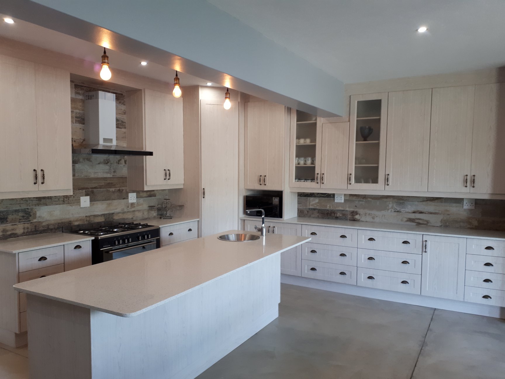Light Farmhouse Kitchen with Rustic Backsplash
