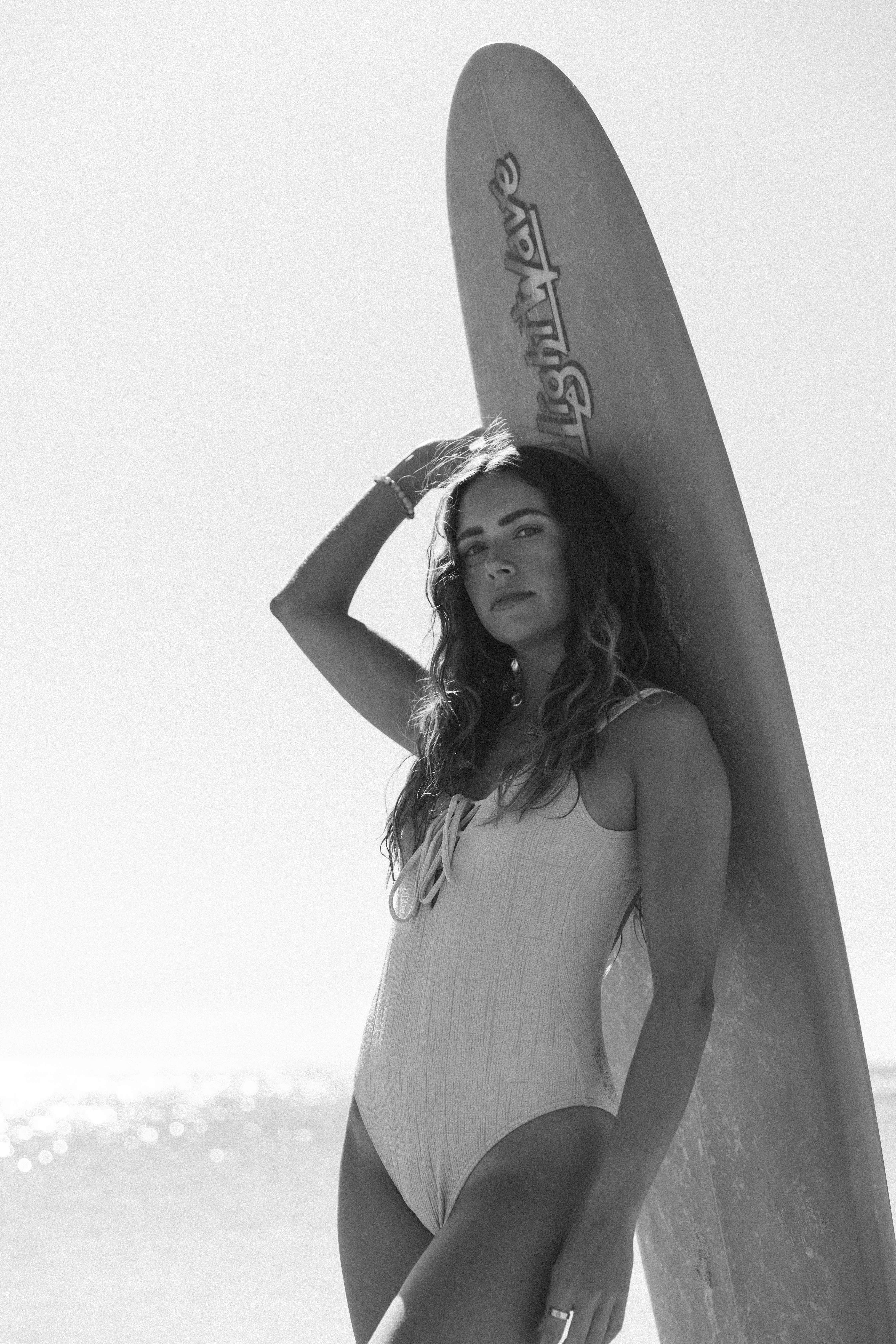 Black and white portrait with surfboard curly hair