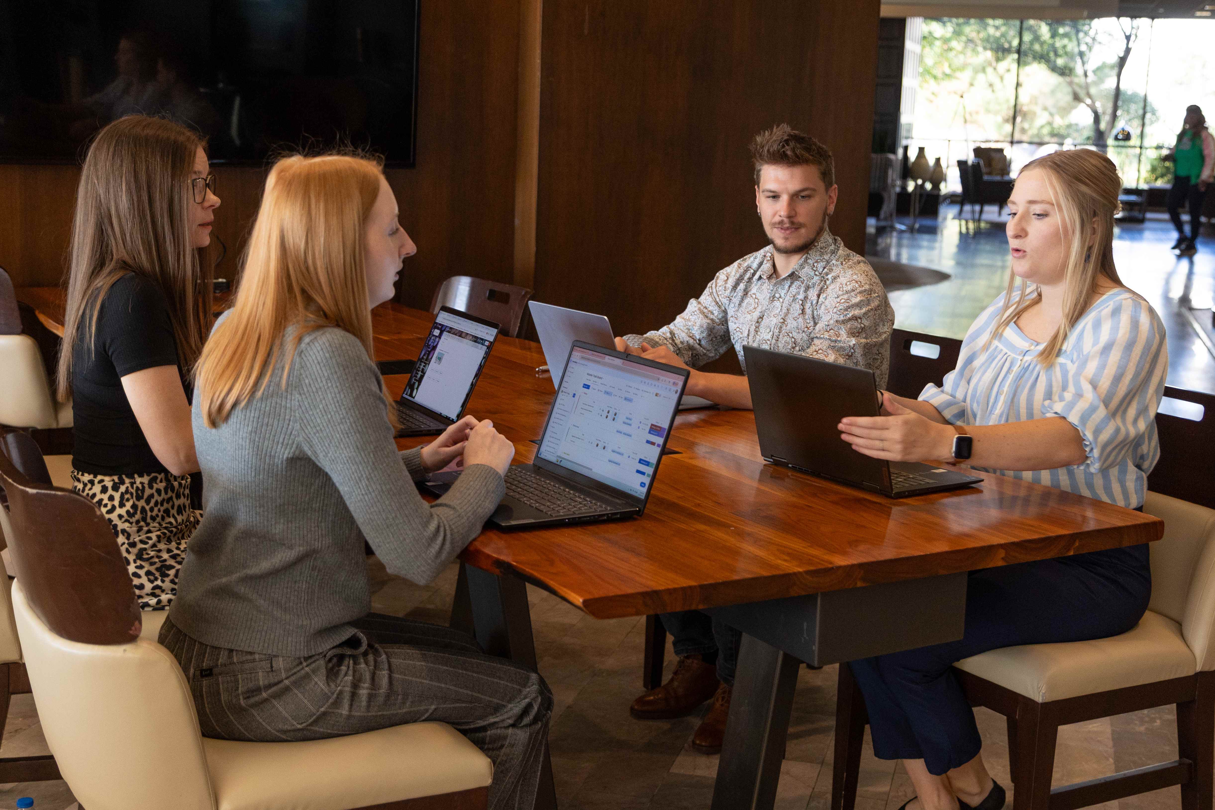 The Impact AI team collaborating around a table