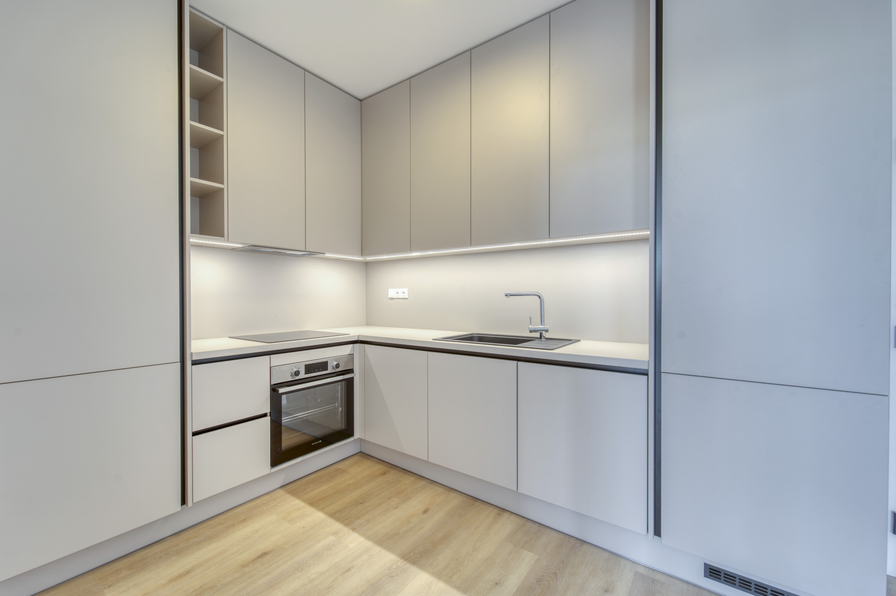 Minimal white kitchen with integrated appliances