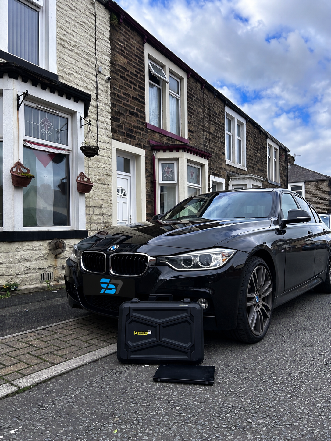 Black BMW 330d outside a customer's home after mobile ECU remapping