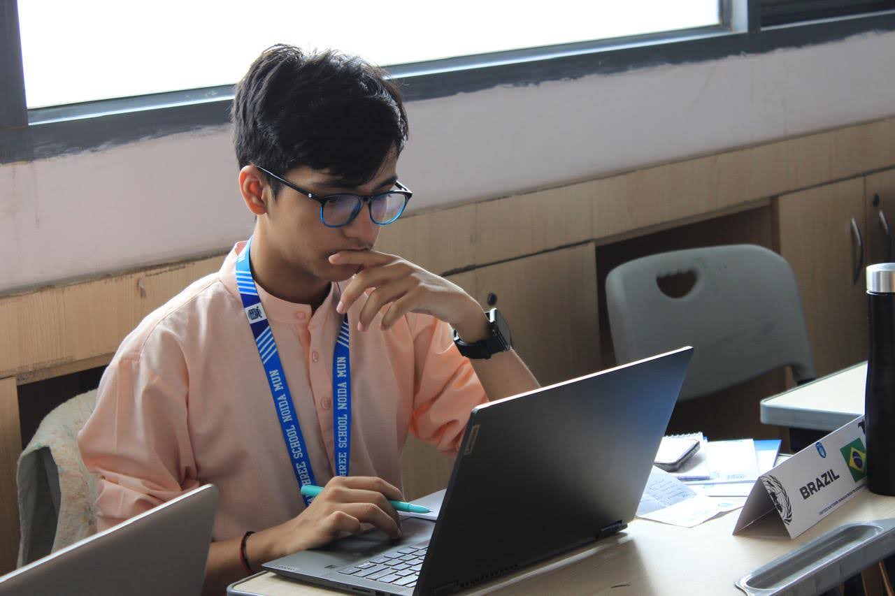 Akshat working at a conference desk