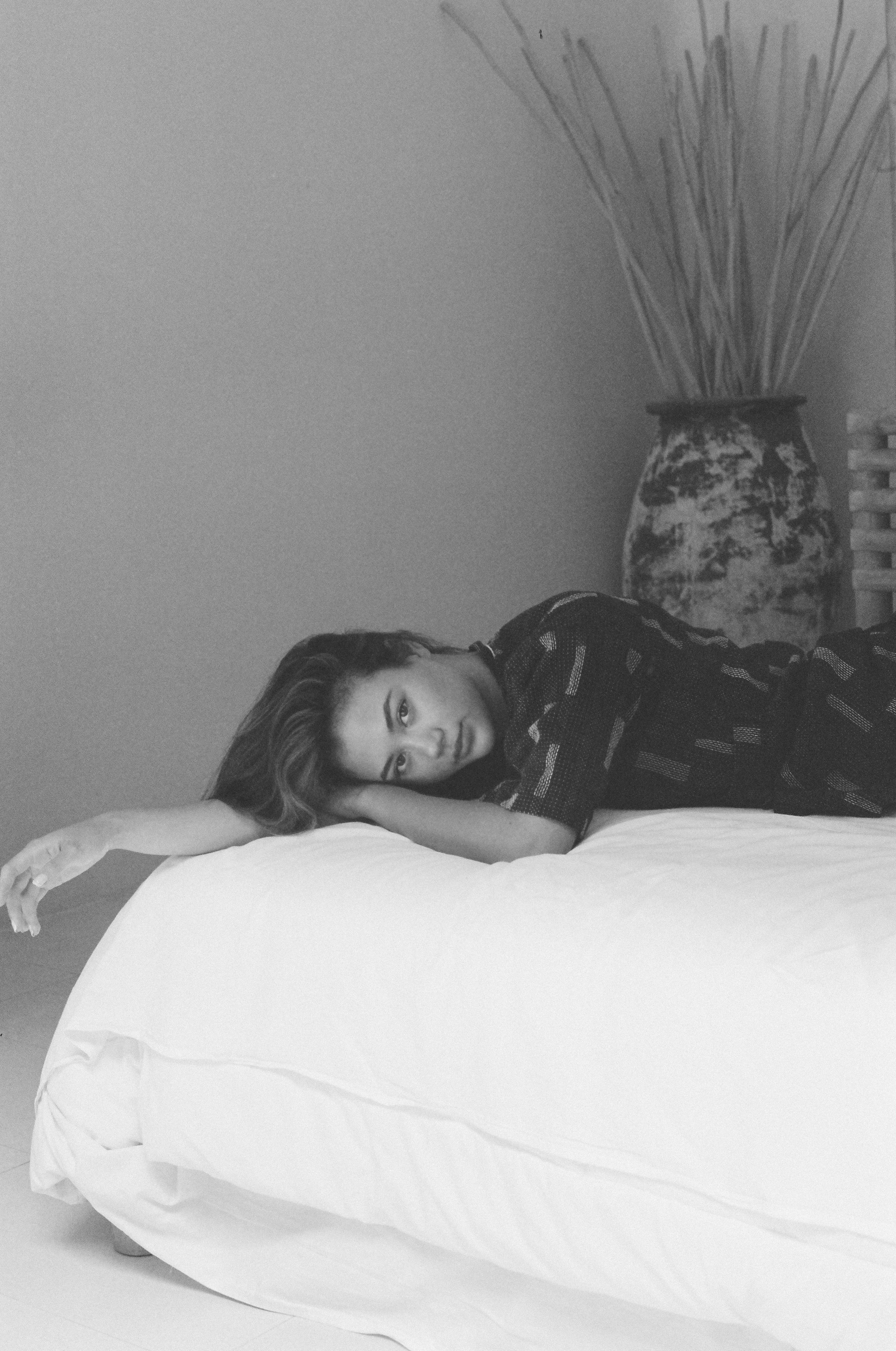 Black and white intimate portrait model on bed with vase film
