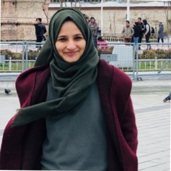 Amina Shiyana wearing a dark green hijab outdoors