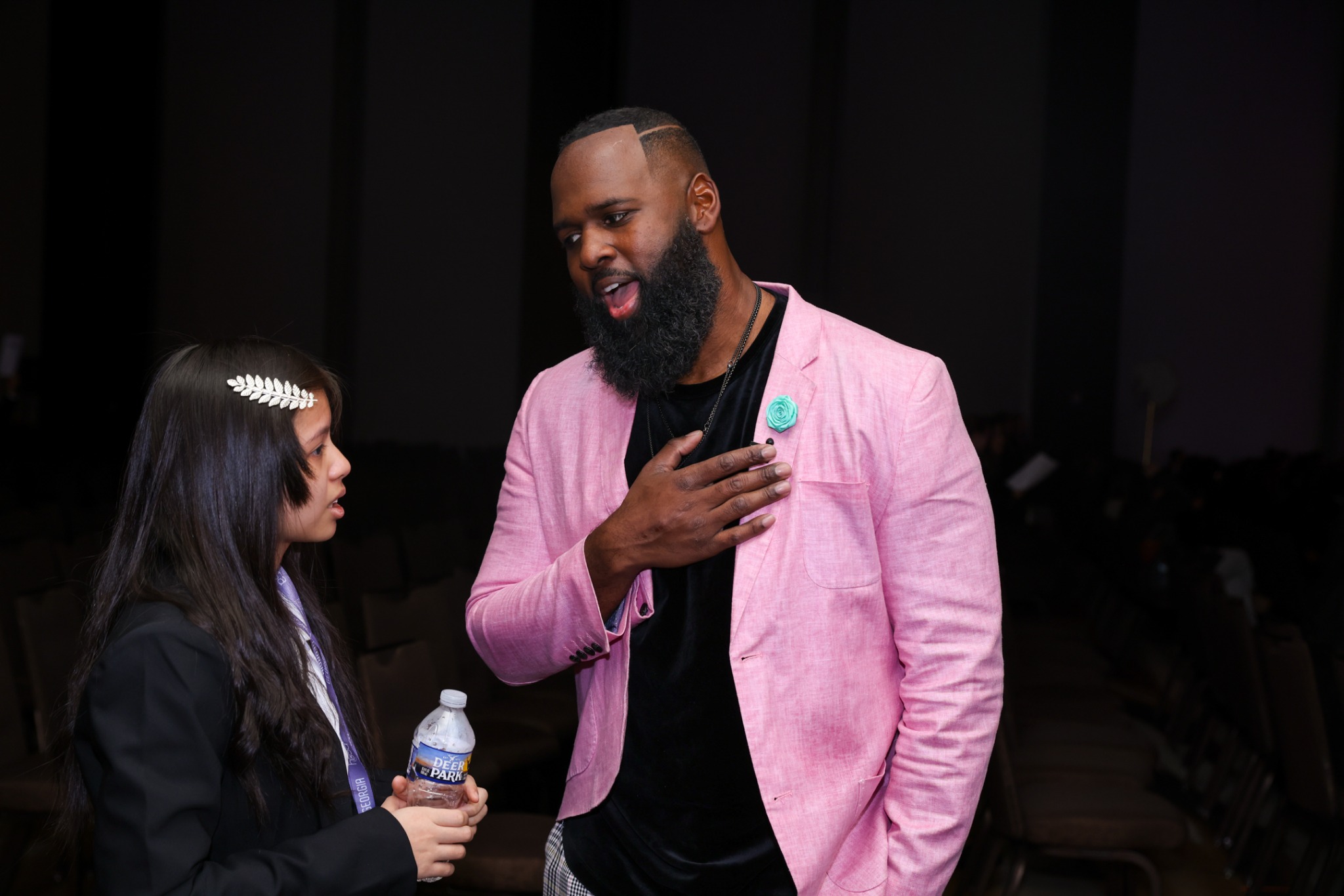 Andre Fluellen speaking with a student backstage