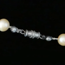 Antique silver barrel clasp connecting pearl strands