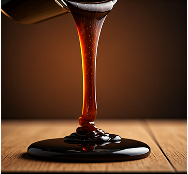 Date syrup stream on wooden surface