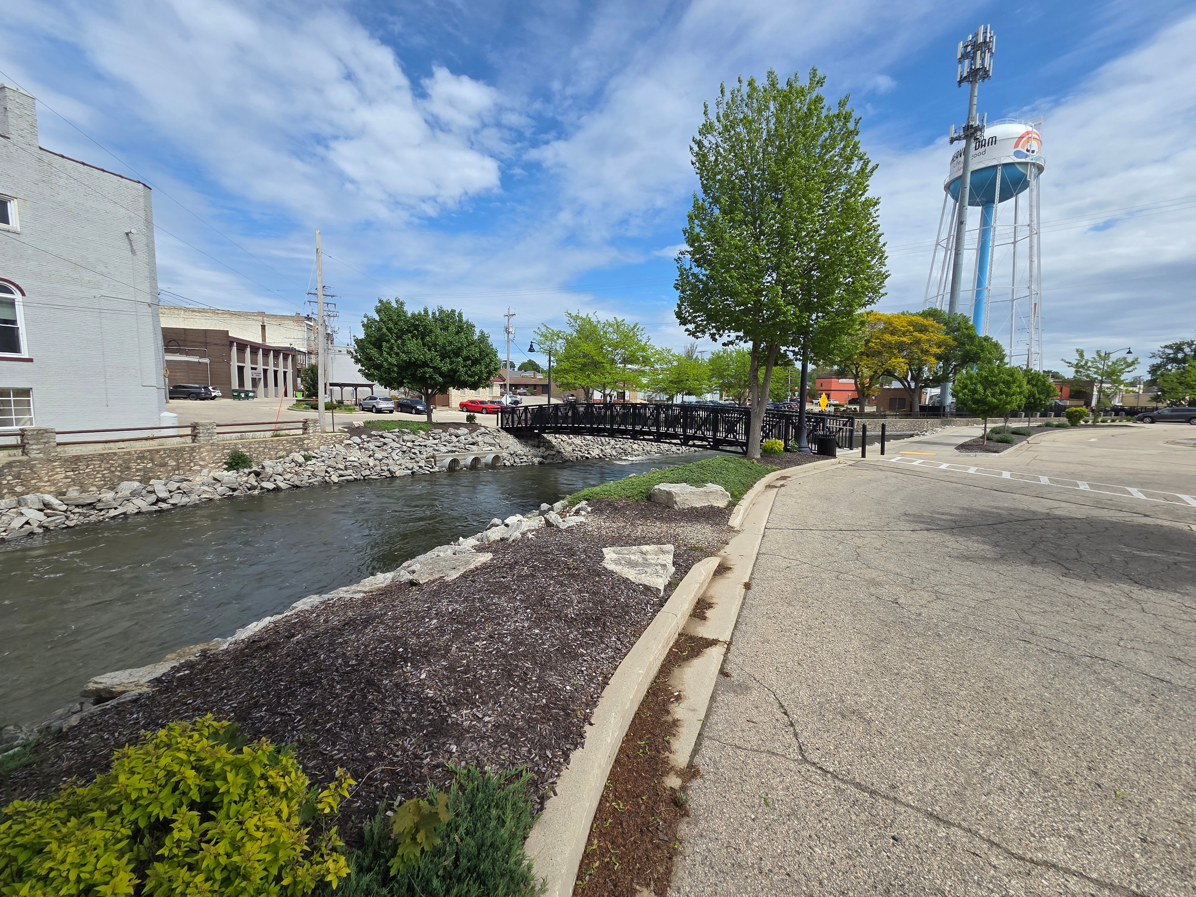 Downtown Beaver Dam, WI riverfront with pedestrian bridge and water tower