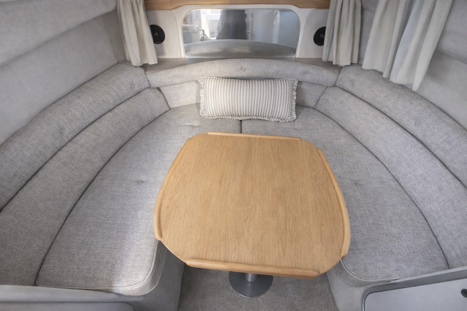 The saloon dinette below deck with wraparound seating and table