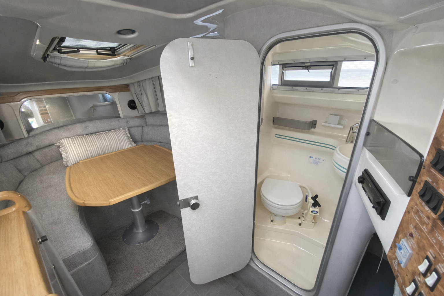 The heads compartment with toilet and sink alongside the saloon