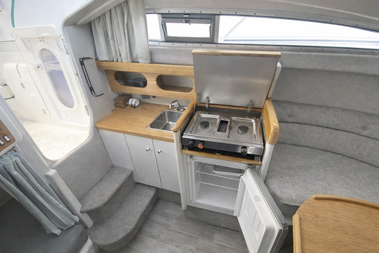 The fully equipped galley with sink, hob and fridge