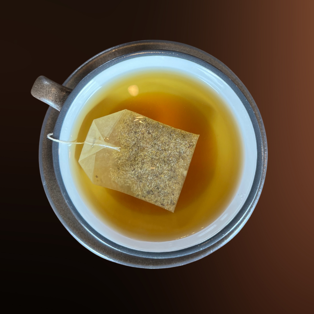 Cup of herbal tea with tea bag steeping