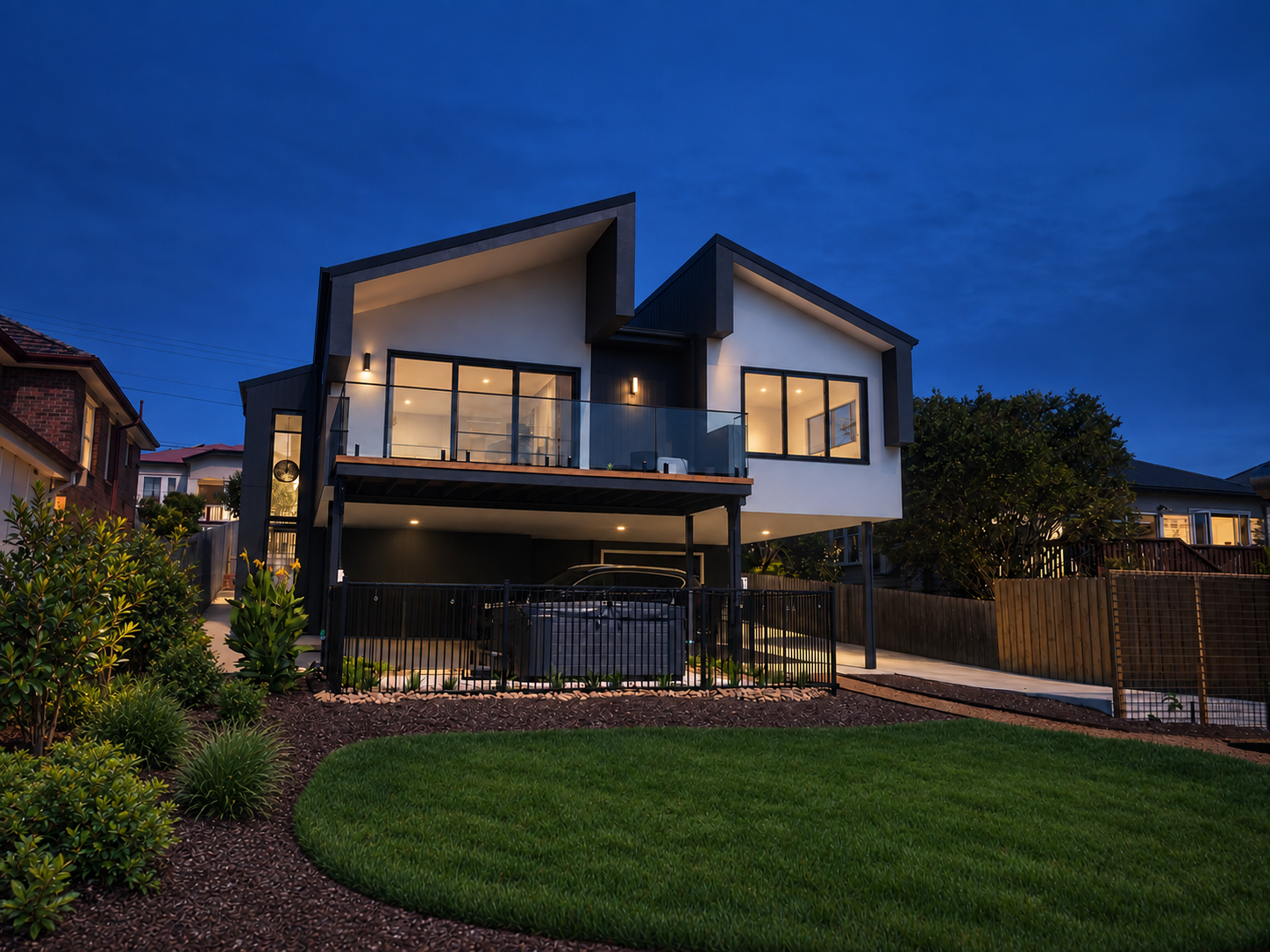 Modern home at blue hour with landscaped garden