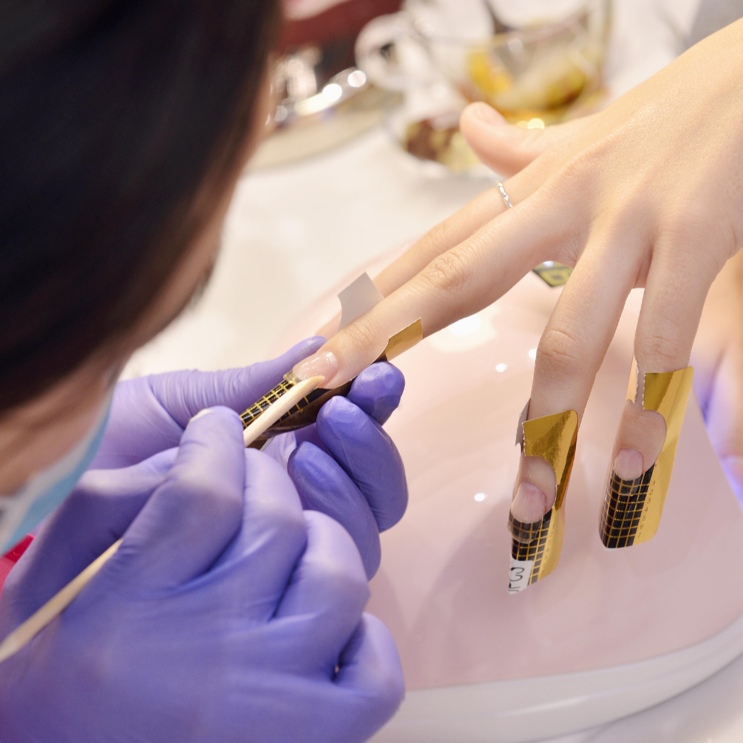 Professional gel nail extension application with gold nail forms by Colour Workshop Singapore