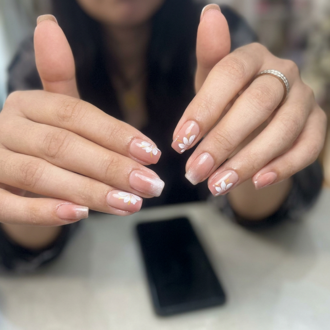 Nude gel nails with white floral leaf nail art by Colour Workshop Singapore