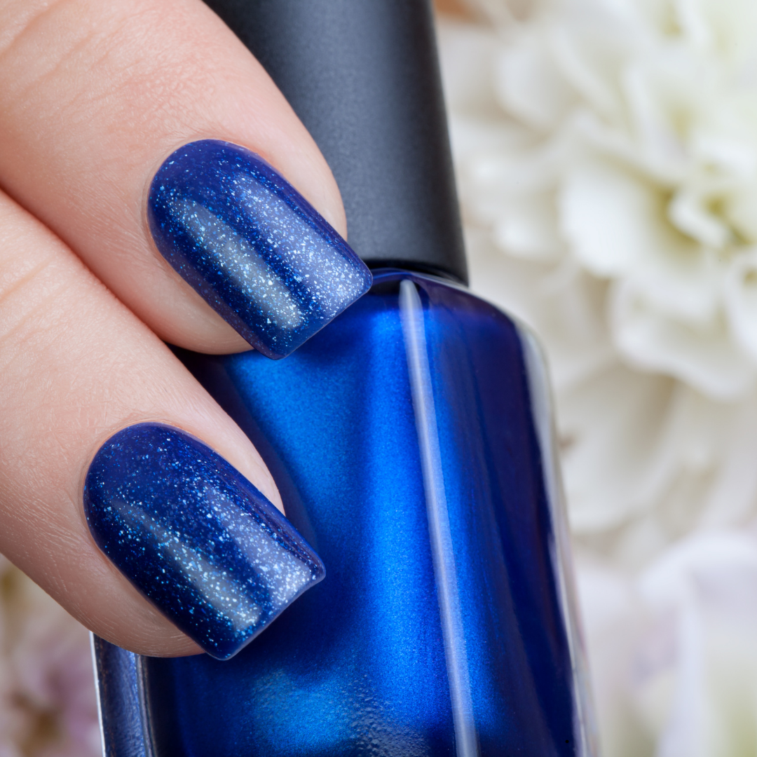Deep blue glitter gel nails with matching nail polish bottle by Colour Workshop Singapore