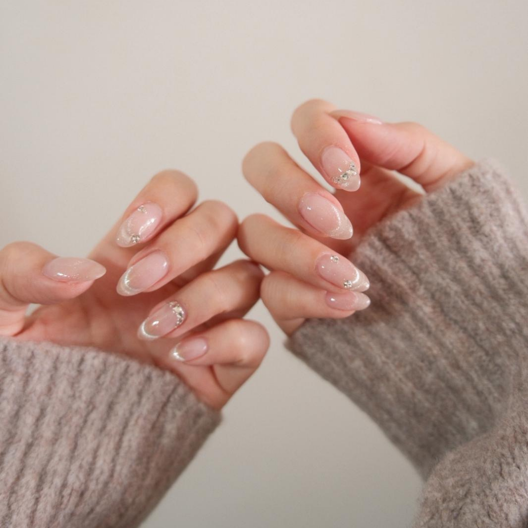 Sheer nude gel nails with crystal embellishments by Colour Workshop Singapore