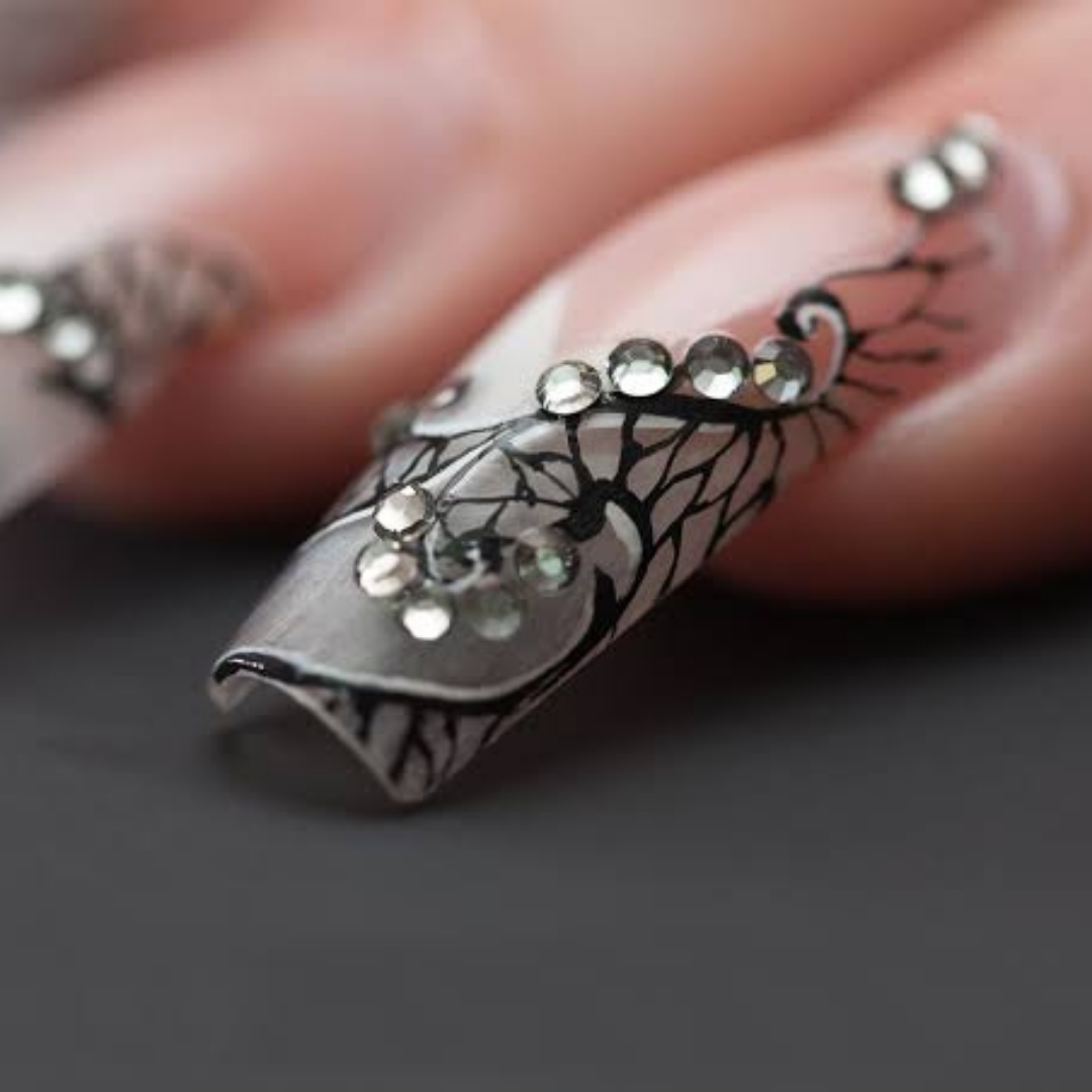 Artistic stiletto nails with black lace design and crystal embellishments by Colour Workshop Singapore