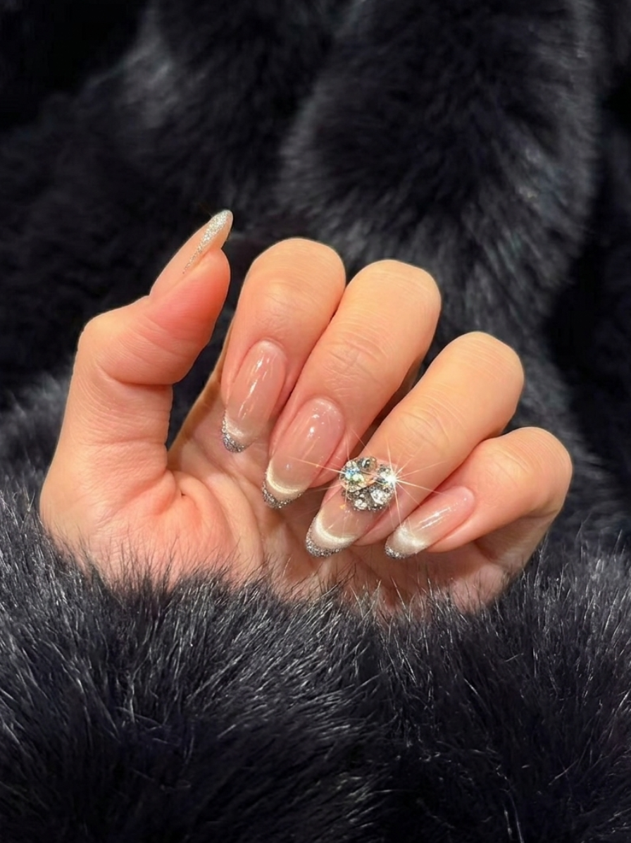 Elegant French tip nails with silver glitter accents and crystal embellishments showcasing nail art at Colour Workshop Singapore