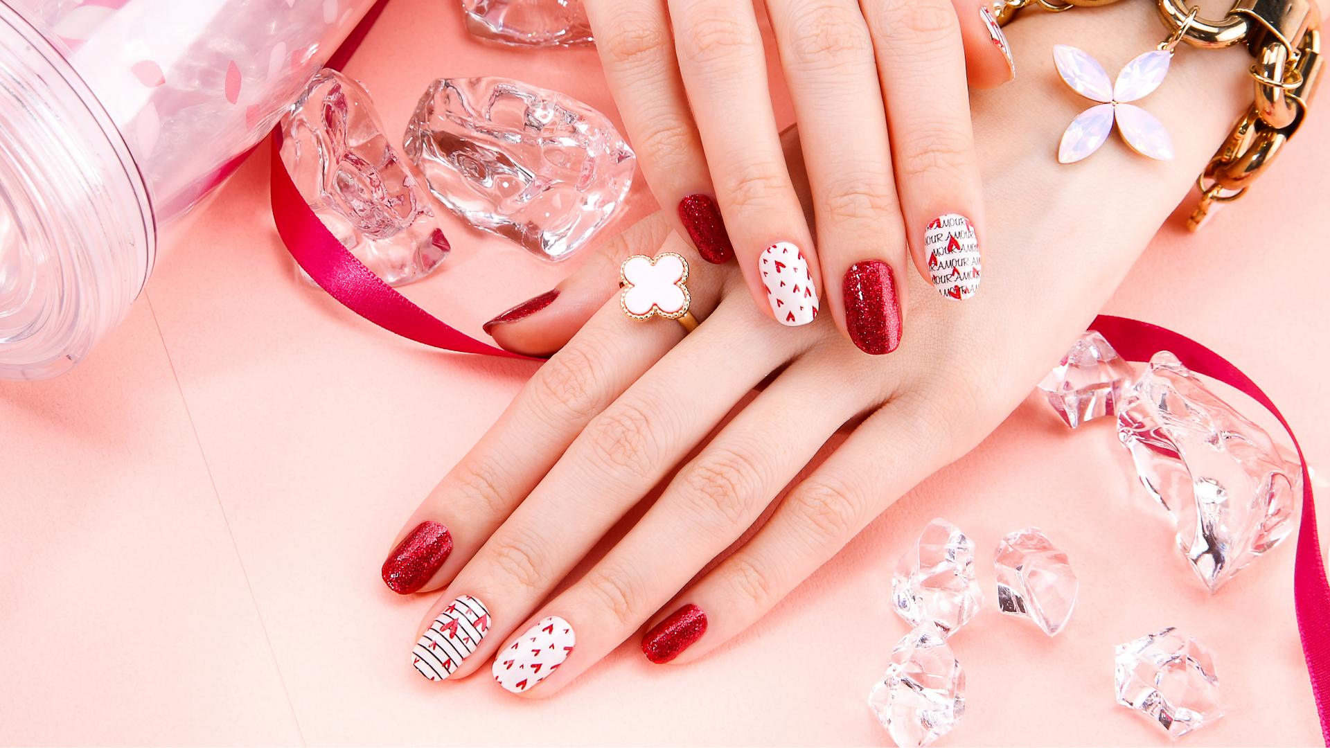 Red glitter nails with love-themed nail art by Colour Workshop