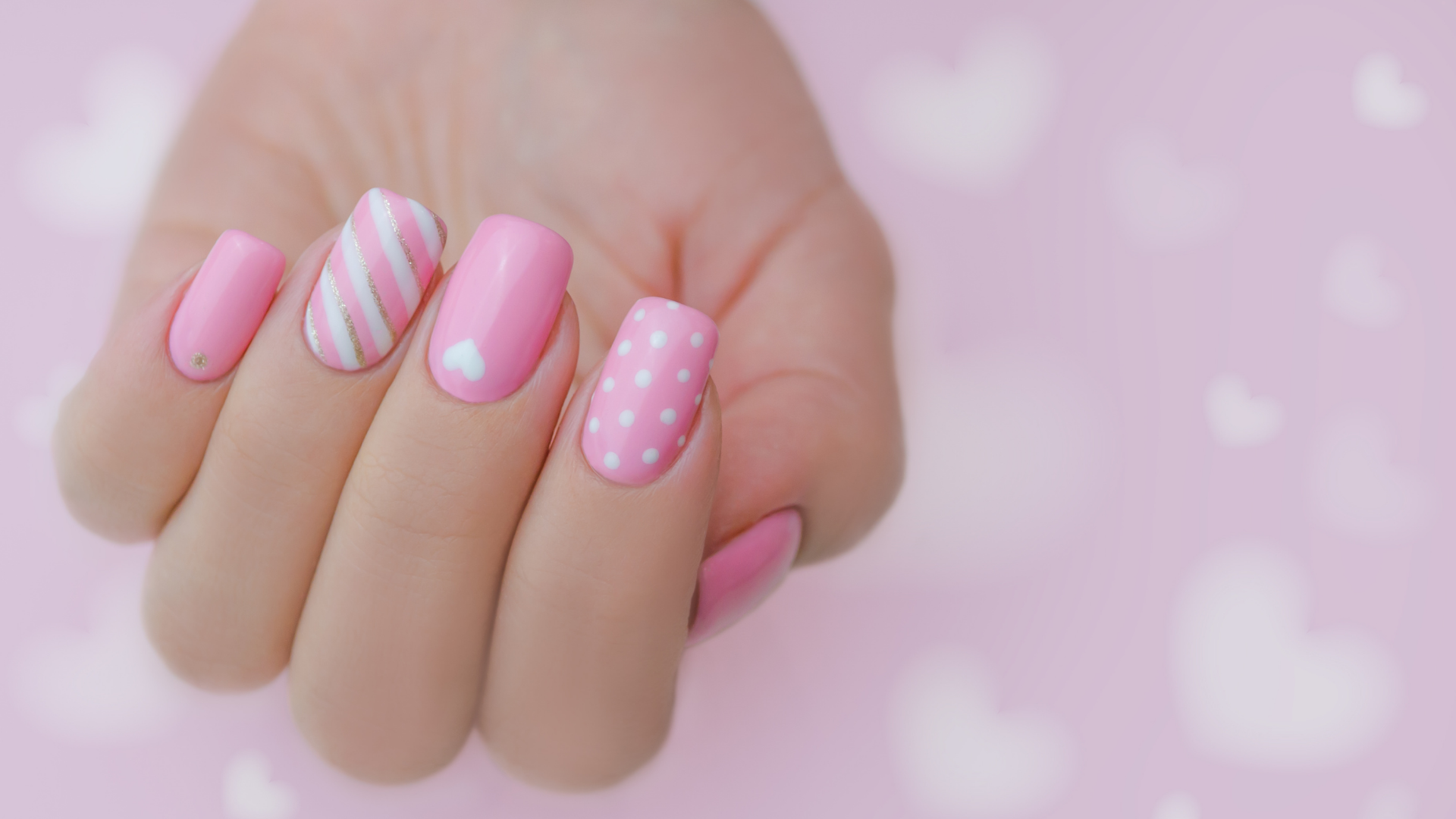 Pink nails with stripes polka dots and heart designs by Colour Workshop
