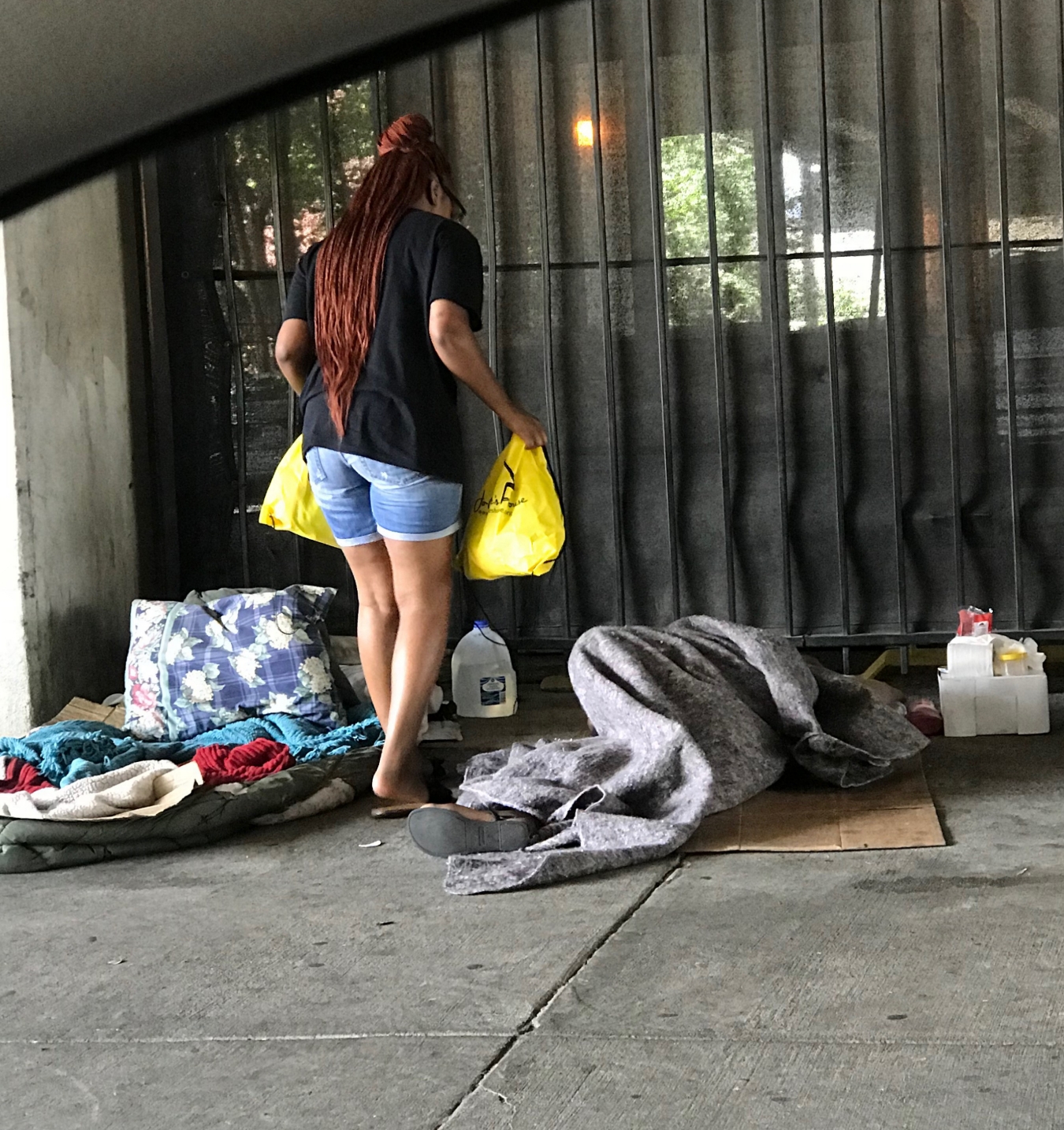 Volunteer delivering supplies under bridge