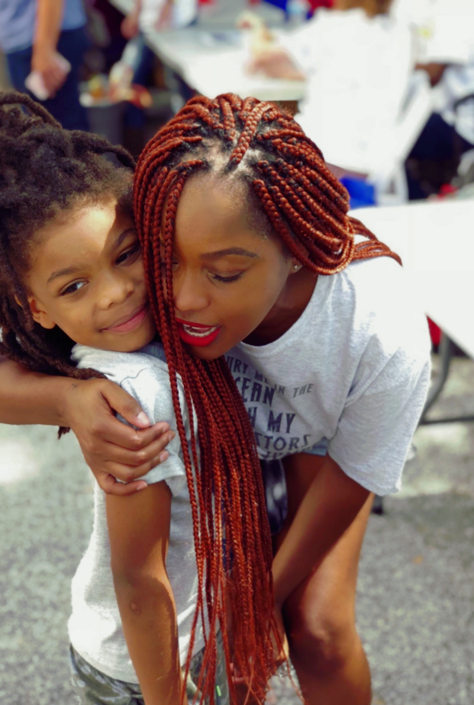 Founder hugging child at community event