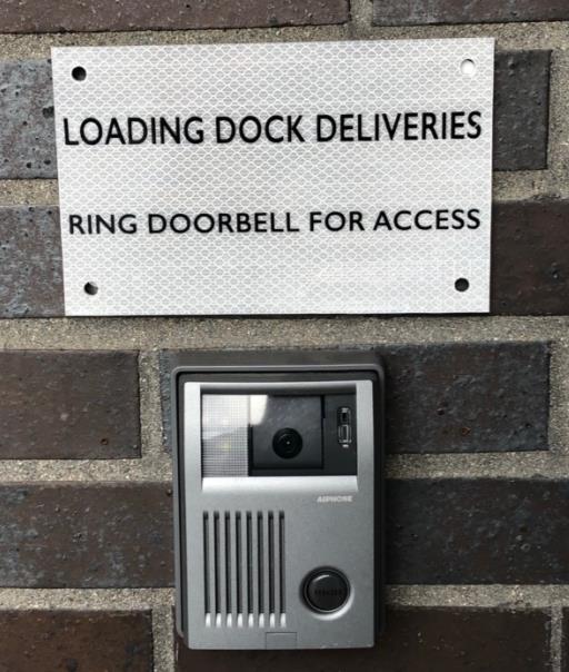 Loading dock doorbell and intercom system with sign reading 'LOADING DOCK DELIVERIES - RING DOORBELL FOR ACCESS'