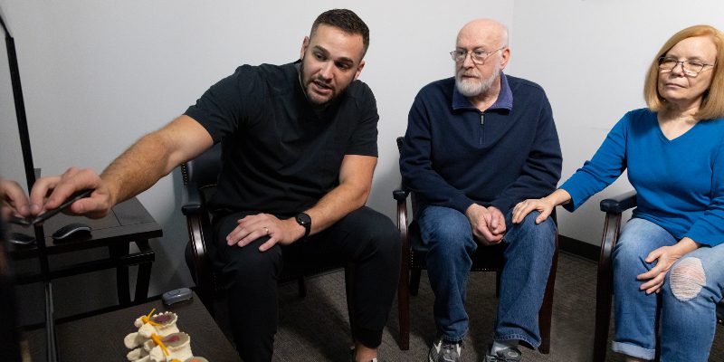 Chiropractor educating patients about carpal tunnel syndrome treatment