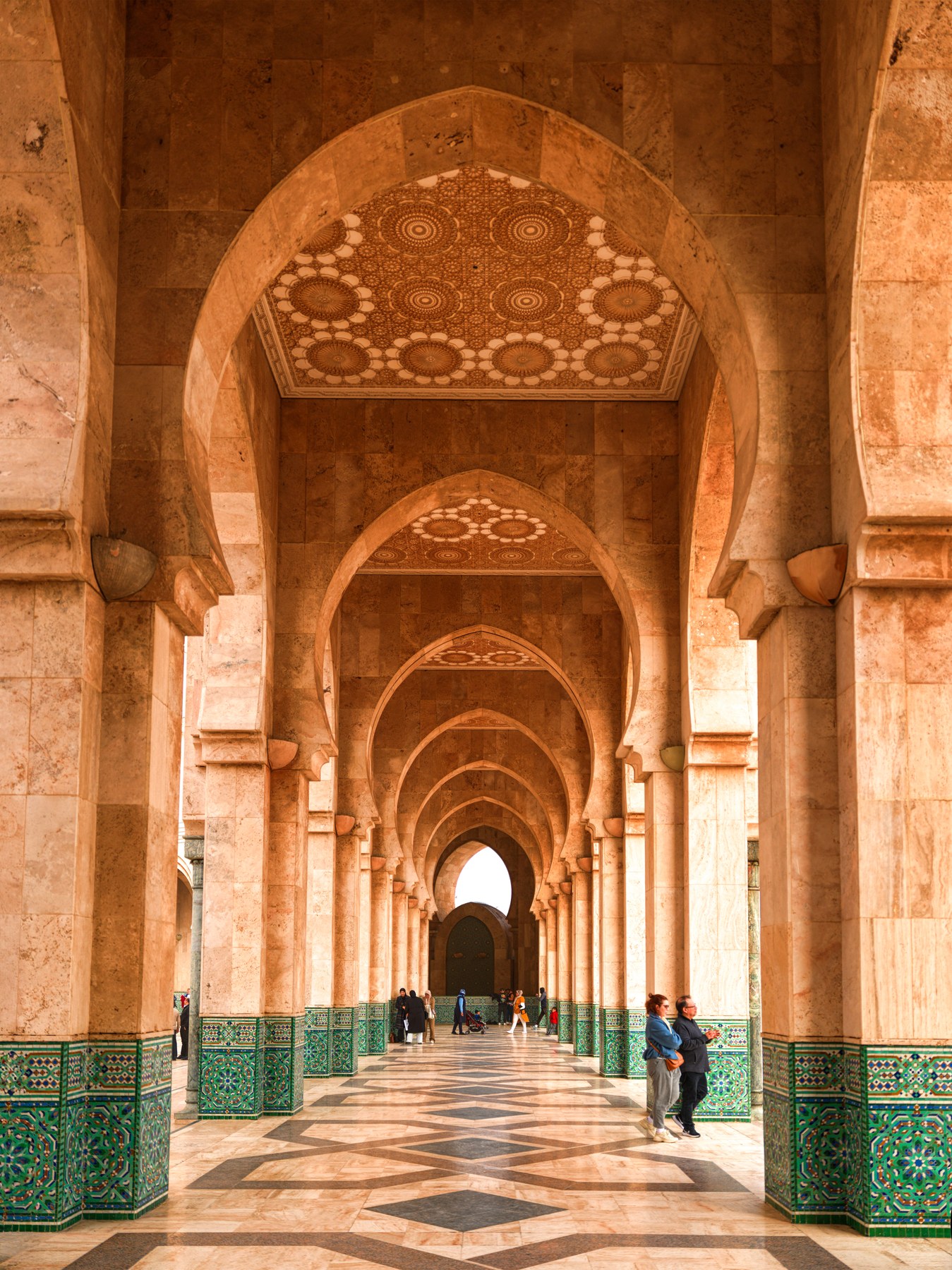 Hassan II Mosque interior corridor with Moroccan arches and tilework