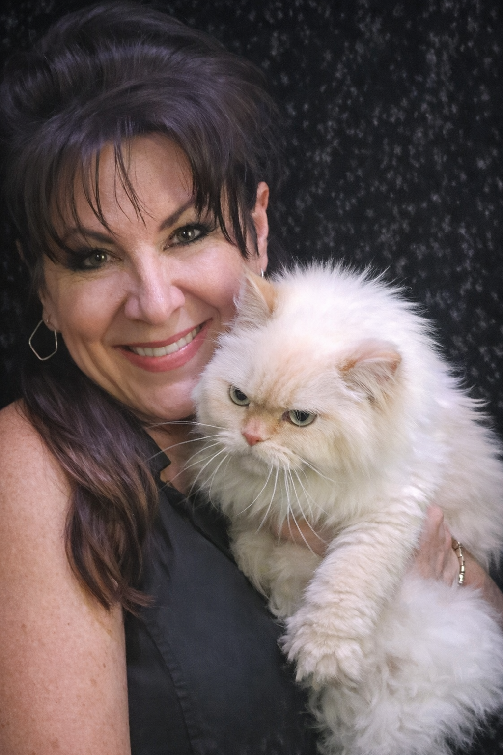 Owner holding and comforting their cat during no-sedation grooming at Vanity Fur Pet Parlor