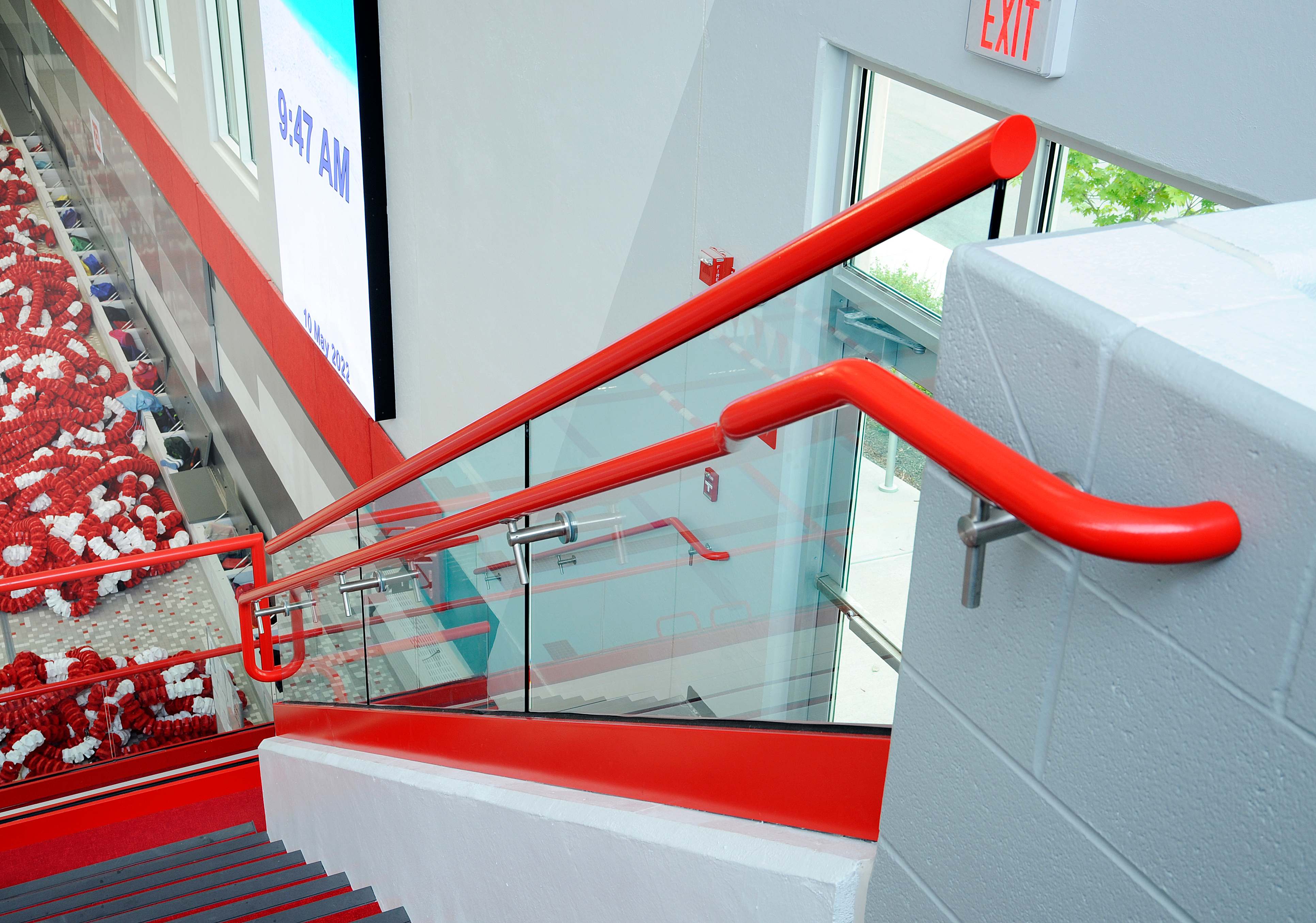 Center Grove HS Natatorium — Structural Glass Stair Close Detail with Red Rail