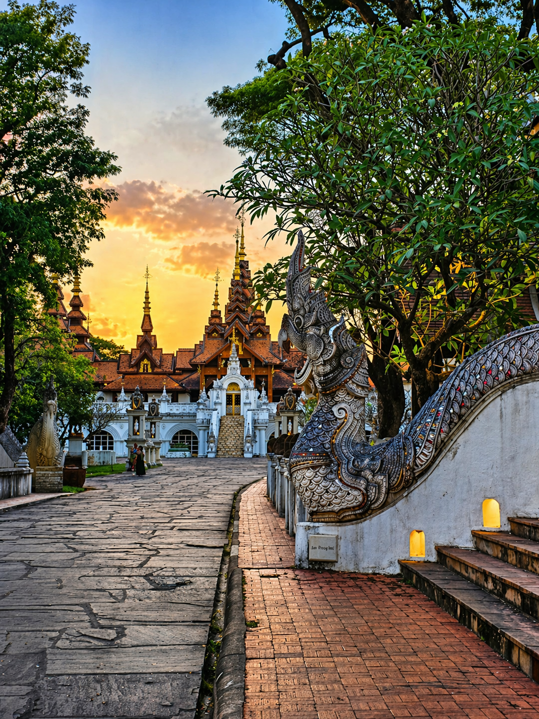 Thai temple at sunset with ornate Naga sculptures