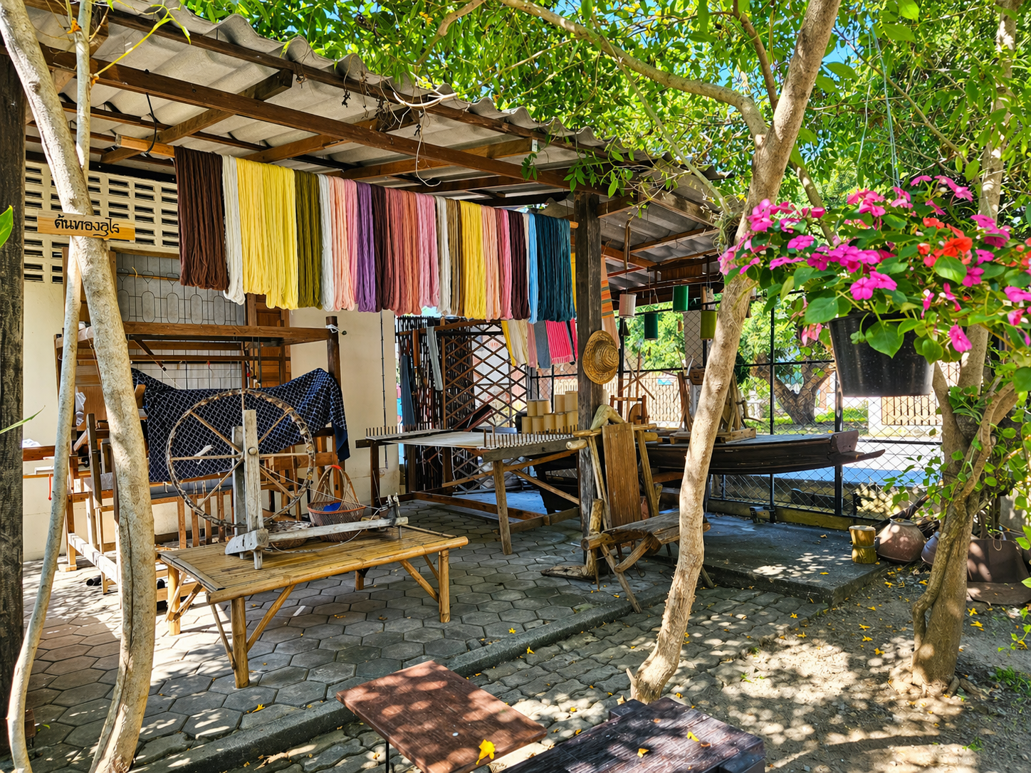 Traditional Thai textile weaving workshop with colorful yarns