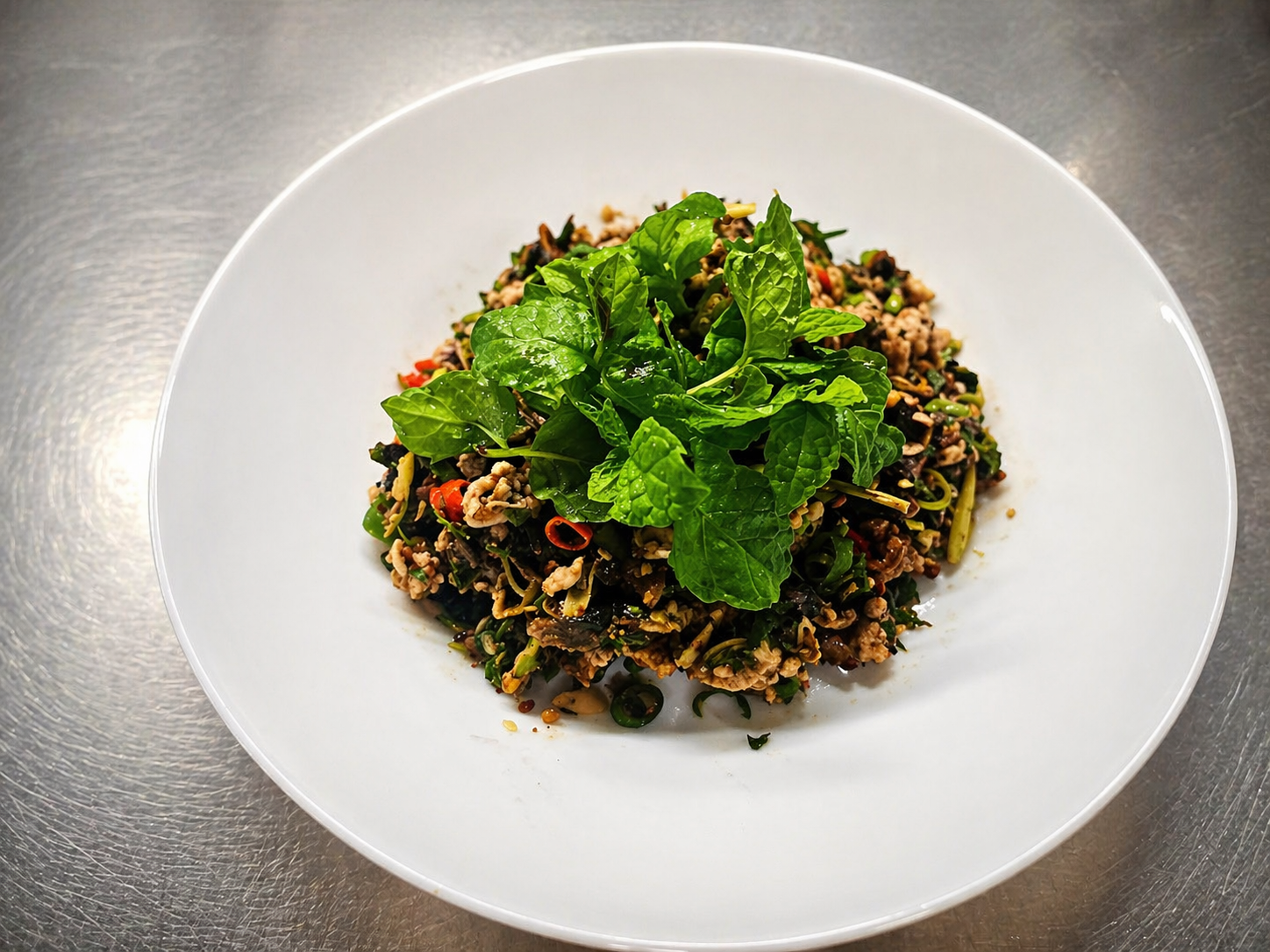 Traditional Thai Larb salad with fresh mint leaves