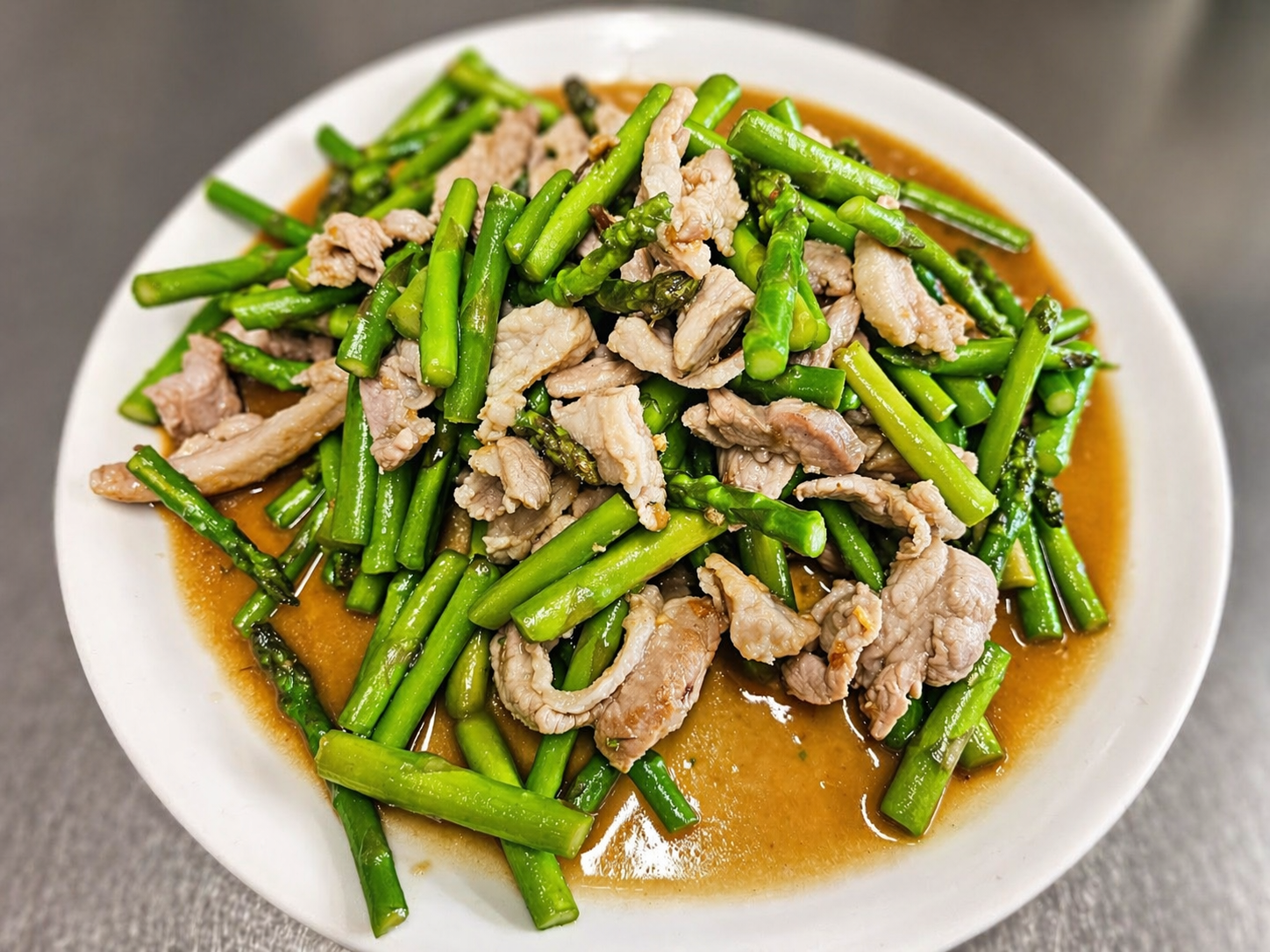 Stir-fried asparagus with pork in savory sauce