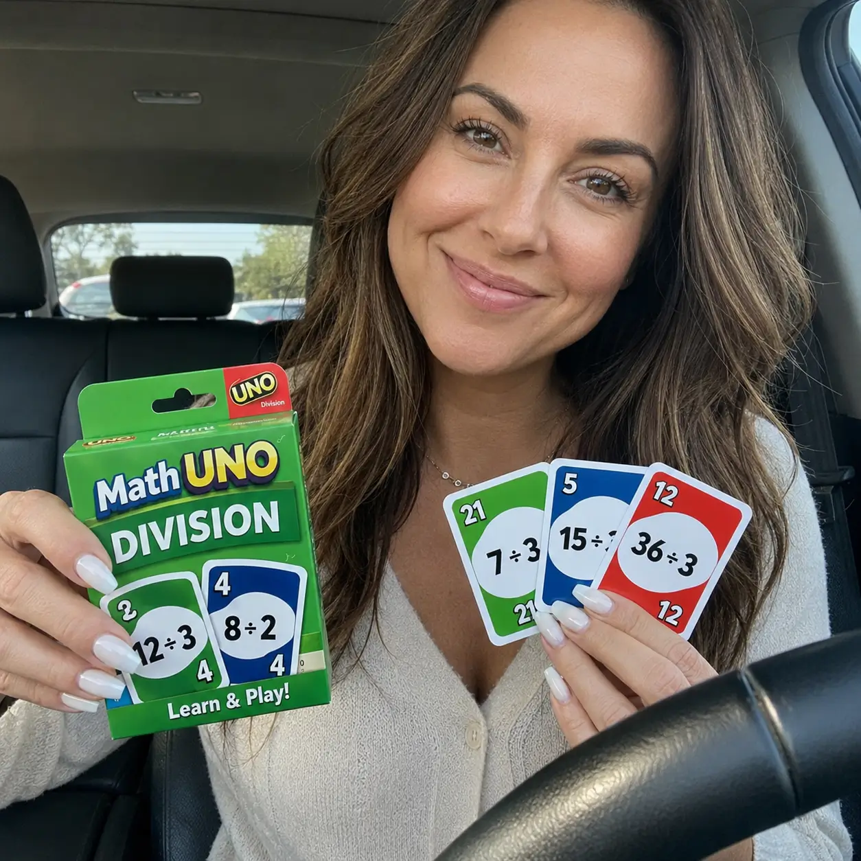 Woman holding the Math Uno Division deck in a car