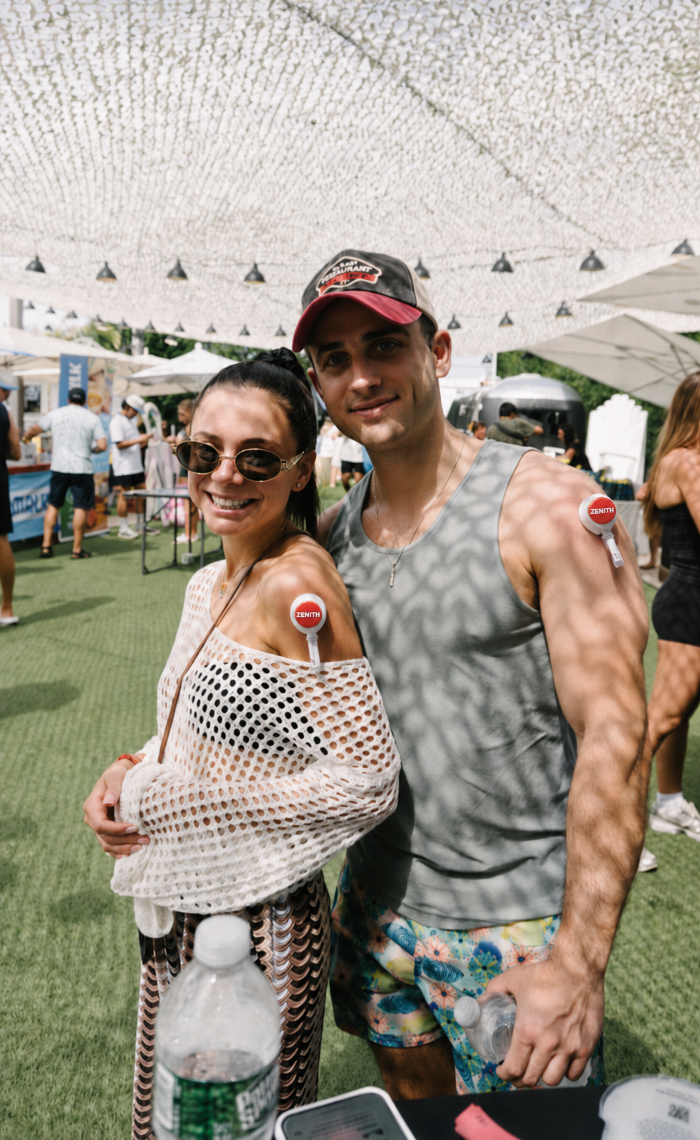 Couple wearing the Zenith blood collection device at an outdoor event