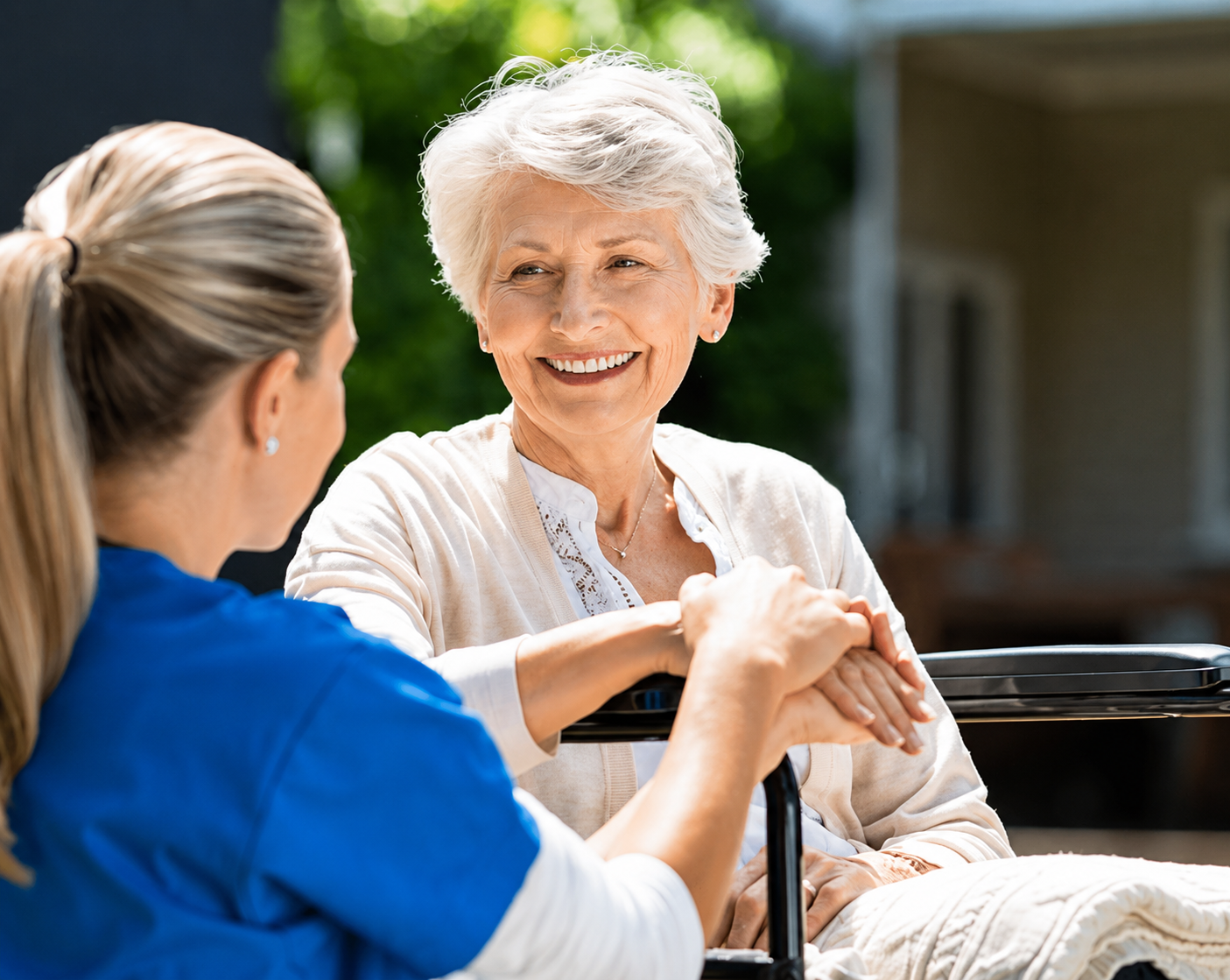 Caregiver supporting an elderly woman with NDIS housing provider services