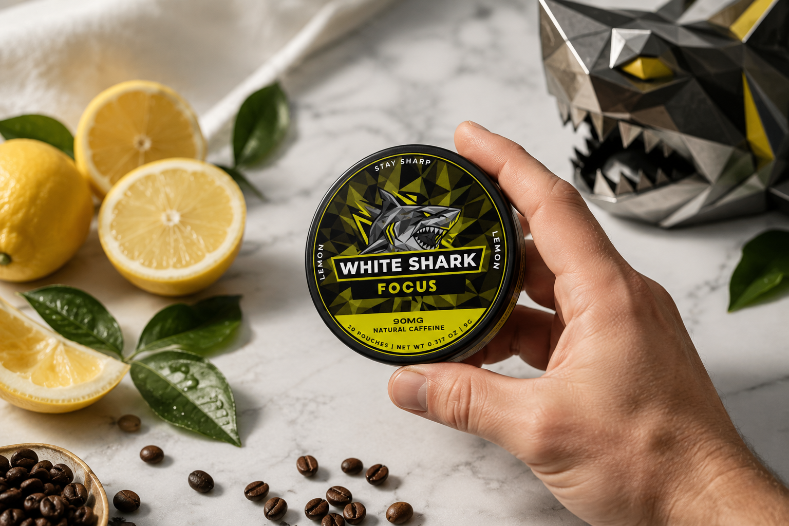 Focus lemon tin on marble with coffee beans and a shark sculpture