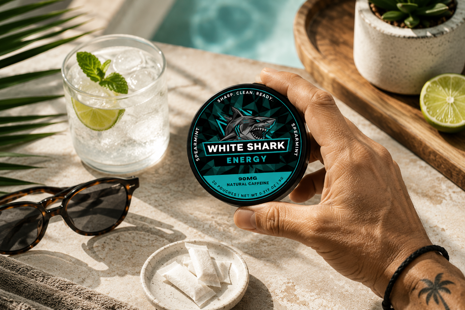 Energy spearmint tin held over a stone counter with a gin glass