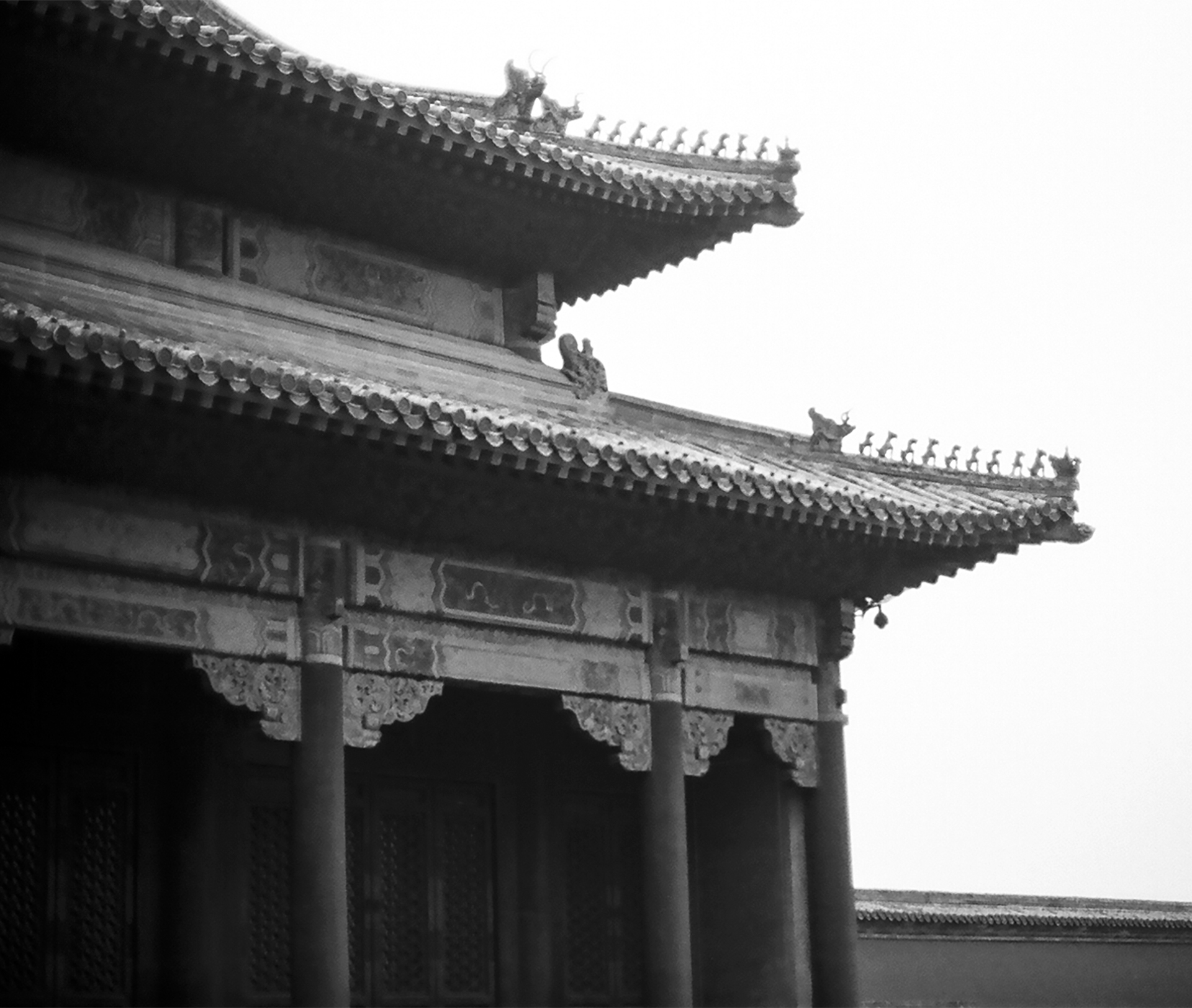 Traditional Chinese palatial building with elaborate curved roof edges and ornamental ceramic details