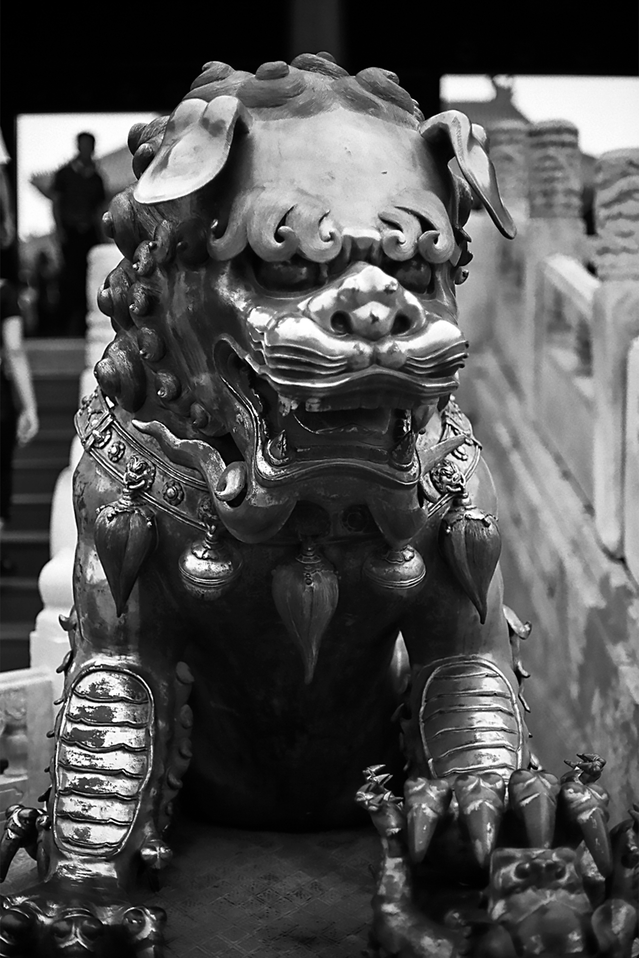 Bronze foo dog guardian lion sculpture with fierce expression and ornate decorative details