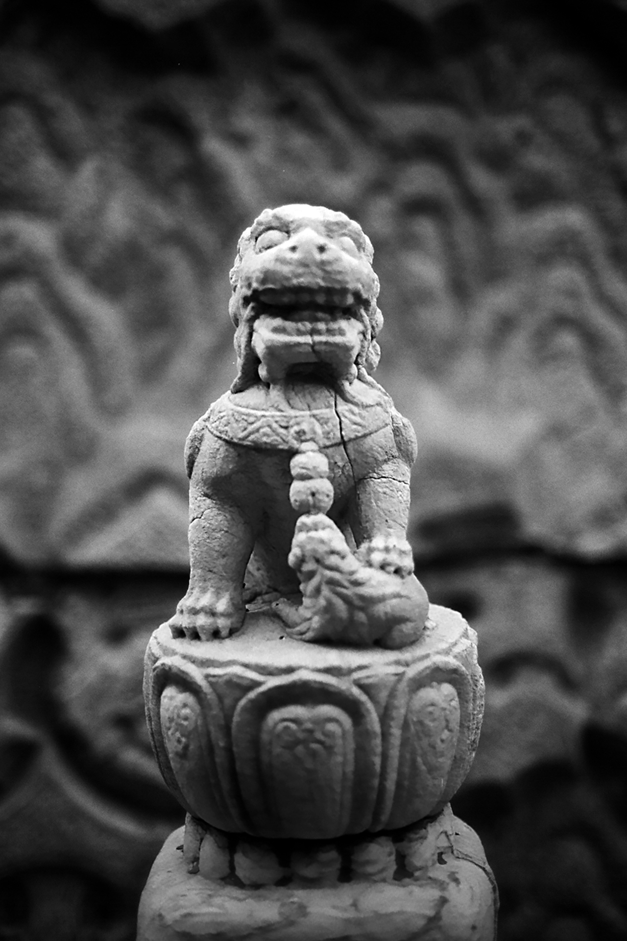 Ornate carved stone lion guardian statue with detailed facial expression and flowing mane