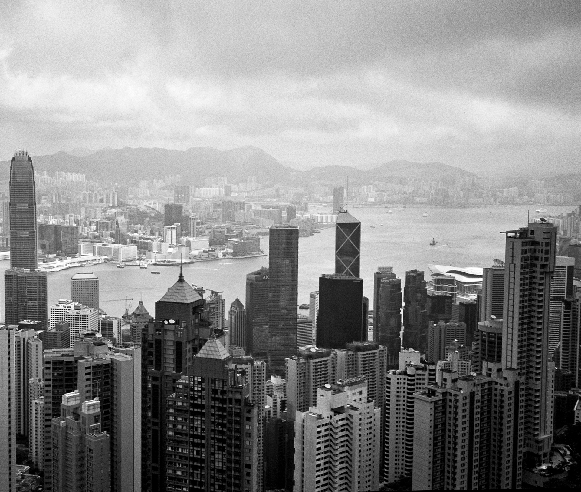 Hong Kong harbor skyline with modern high-rise buildings mountains and waterfront cityscape