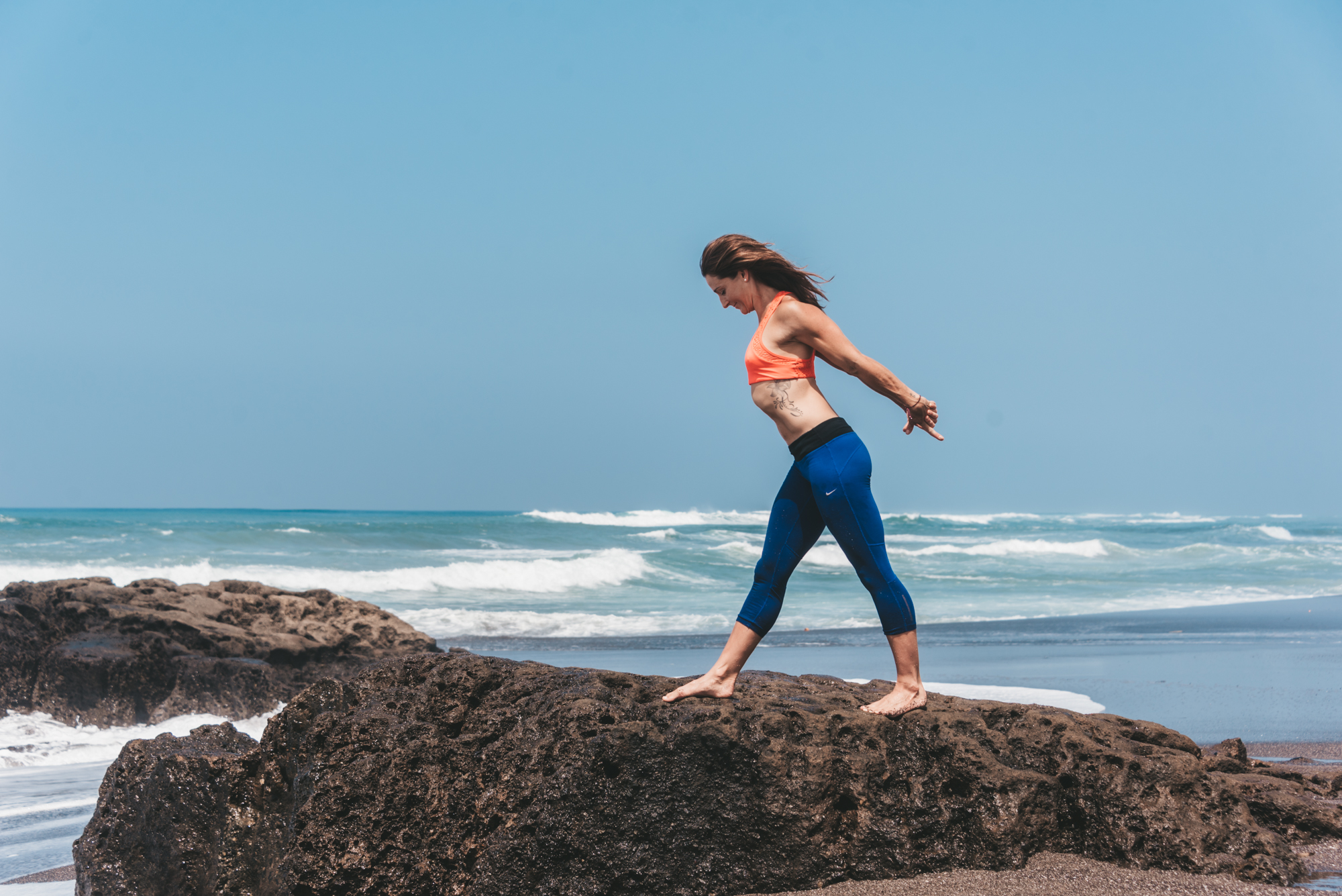 Liz Marsland walking on rocks by the ocean