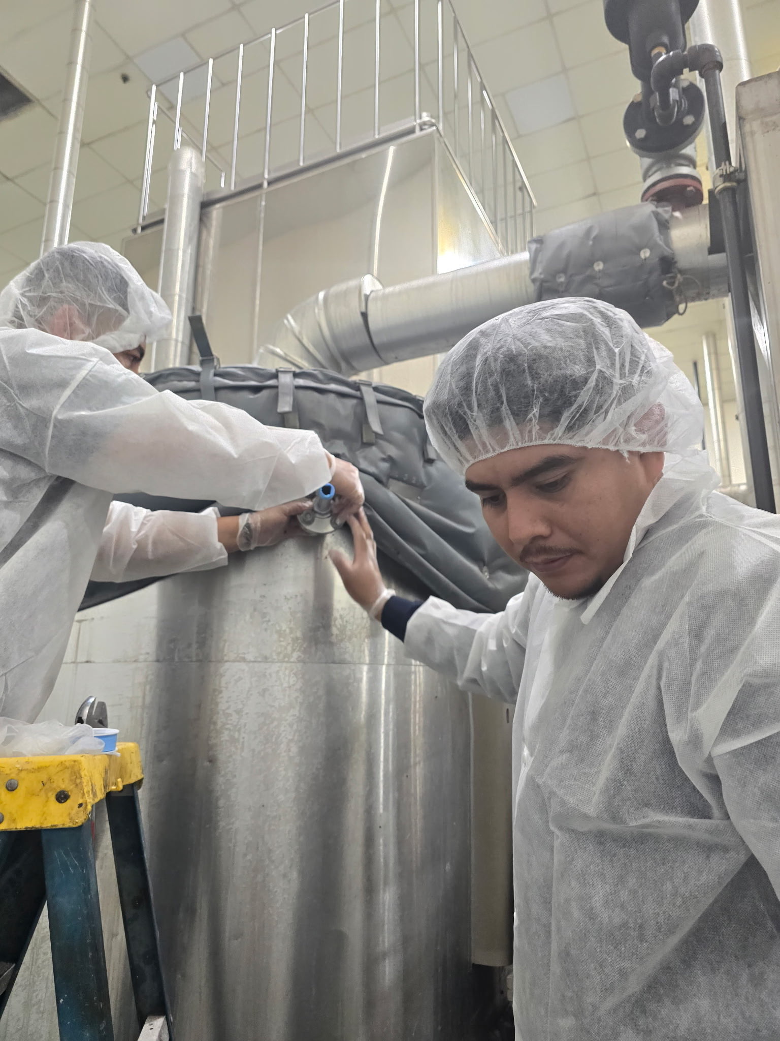 One Time Construction crews fitting process tanks and valves at a food-grade production facility