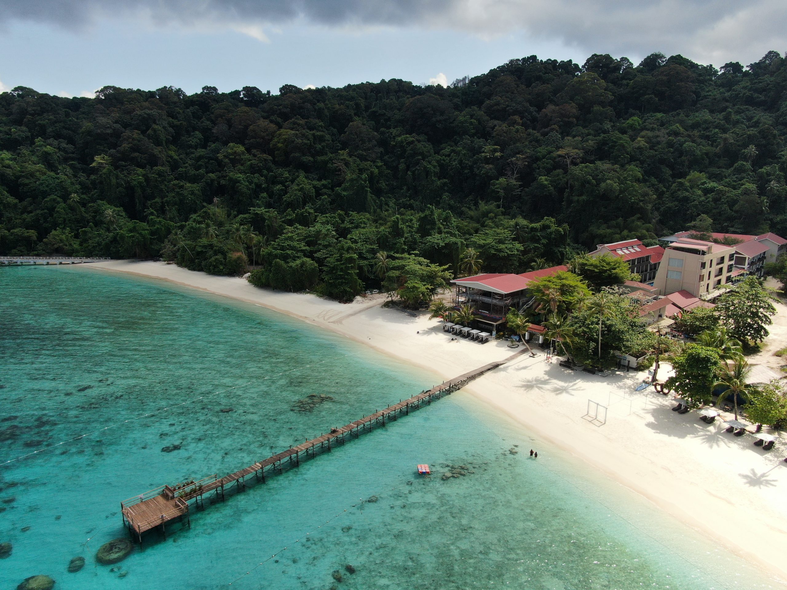 Aerial view of Lang Tengah Island white sand beach, wooden jetty and turquoise sea, Terengganu Malaysia