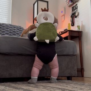 Baby standing and walking with SafeYourBaby Turtle backpack